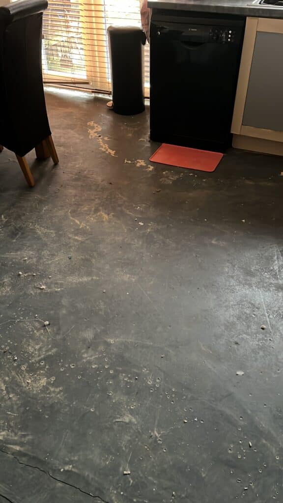 Holly Jolly Christmas is not in my house this year- photo of a black floor which should have a floor covering